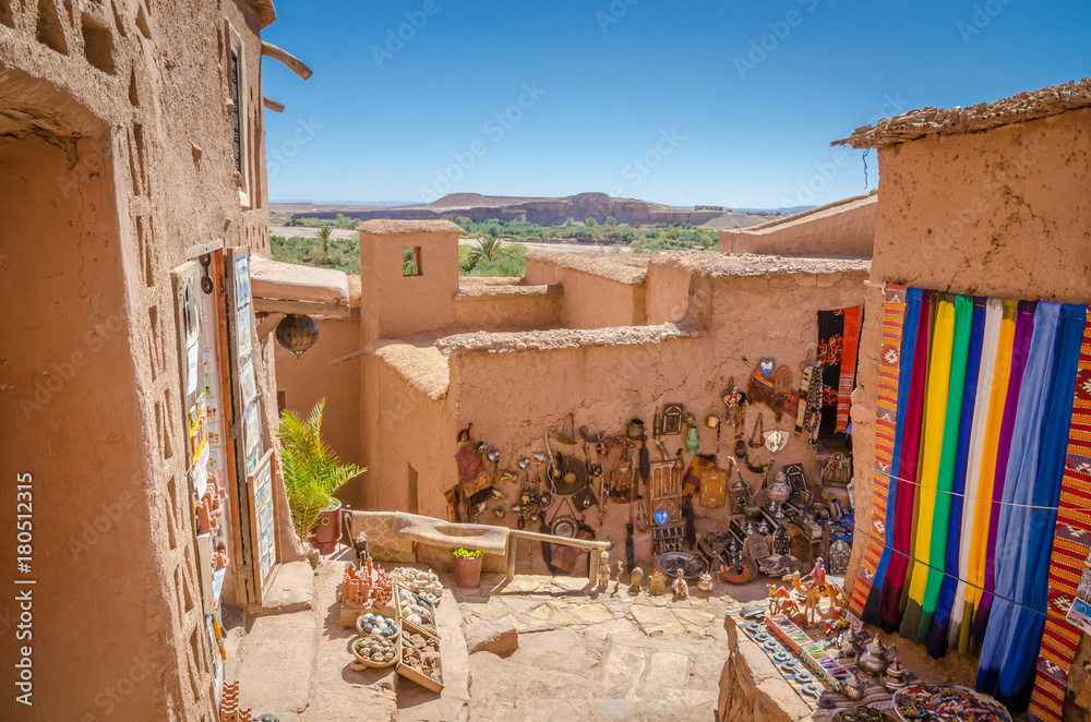 Fototapeta premium Narrow streets of Kasbah Ait Ben Haddou with traditional moroccan souvenirs, Morocco