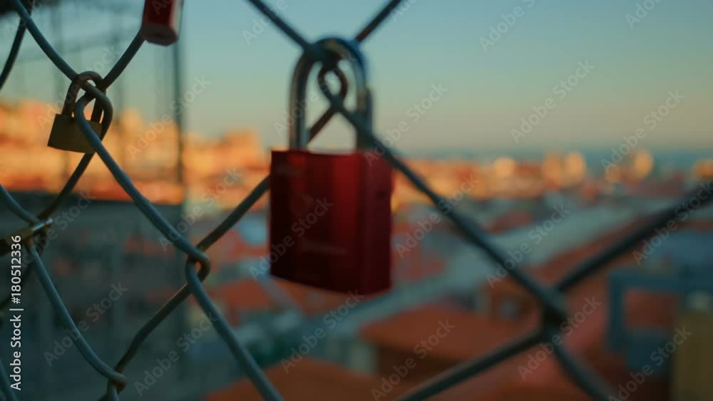 From Lisbon with love - Rack focus golden hour shot revealing the downtown of Lisbon, Portugal from a padlock. The Baixa Pombalina downtown district covers over 235,000 sq. m. from Praca do Comercio. From Lisbon with love - Rack focus golden hour shot revealing the downtown of Lisbon, Portugal from a padlock. The Baixa Pombalina downtown district covers over 235,000 sq. m. from Praca do Comercio.