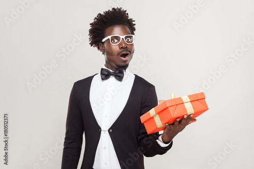 Amazement man holding gift box and shocked. photo