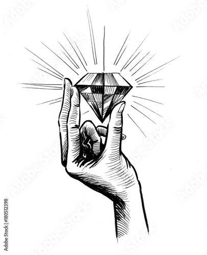Hand holding a big shiny diamond