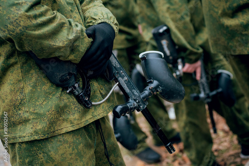 Men with guns playing at paintball. Outdoors © romaset