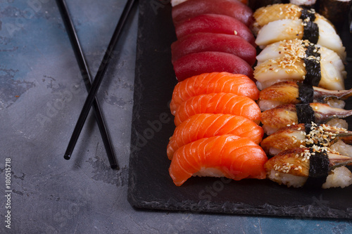 Japanese sushi set close up with wooden black chopsticks
