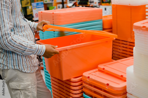 Close up image of person choosing selecting container on the indoors background. Buying, checking, preparing celebration, wholesale fabric production
