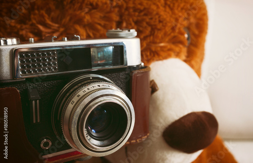 Teddy bear with vintage 35mm camera photo