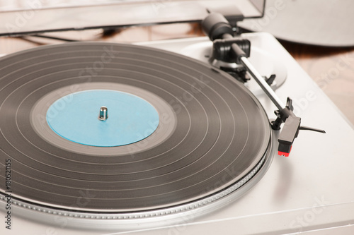 Moving magnet cartridge on the tonearm standing on a vinyl record