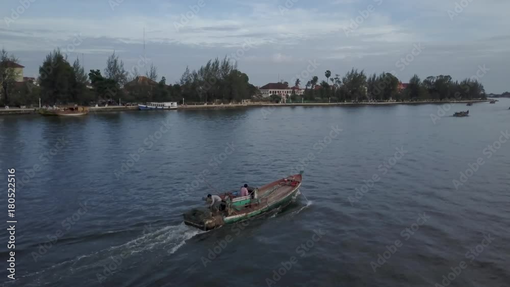 Drone following fishing boat on the Prek Kampong river in Kampot, Cambodia. Drone following fishing boat on the Prek Kampong river in Kampot, Cambodia.