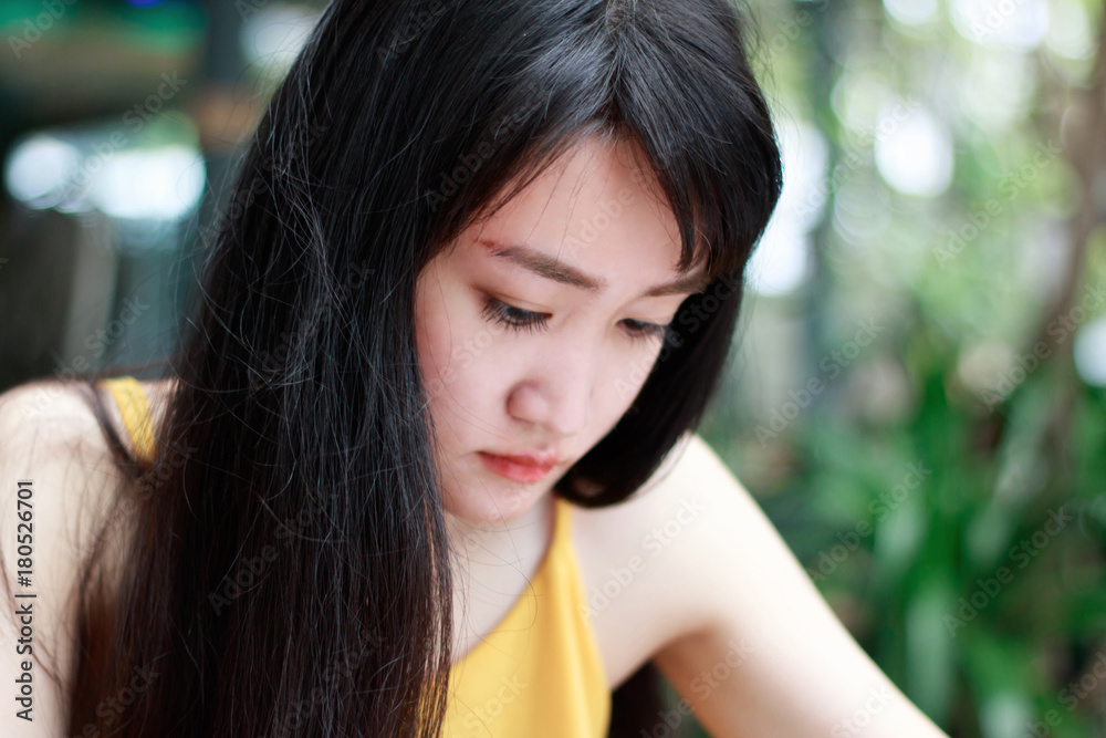 Obraz premium Close up of young Asian woman with blur background.