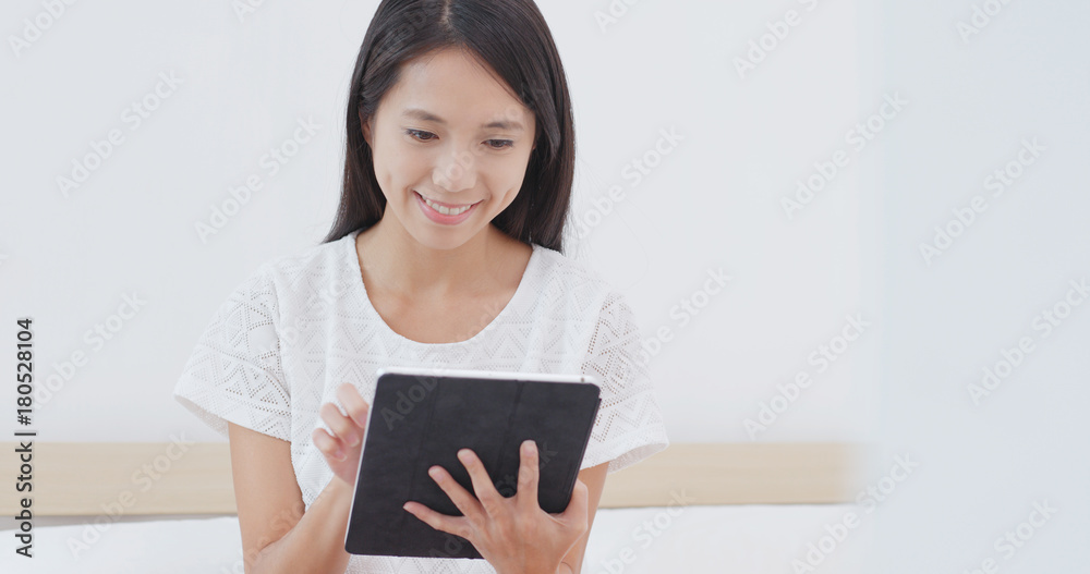 Woman posting on social media with tablet computer Woman posting on social media with tablet computer