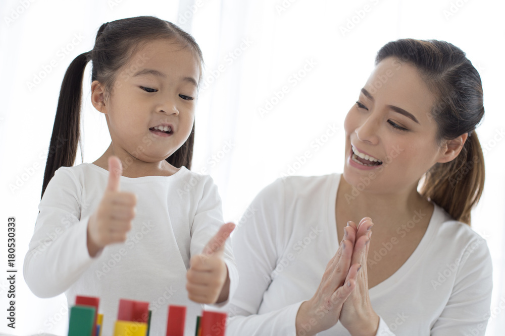 Mam playing toy with her Daugther at home. Happy Family Concept. Mam playing toy with her Daugther at home. Happy Family Concept.