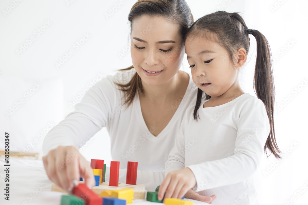 Mam playing toy with her Daugther at home. Happy Family Concept. Mam playing toy with her Daugther at home. Happy Family Concept.