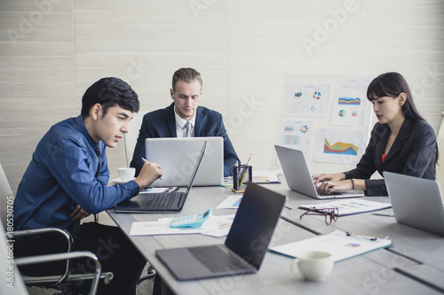 Young Business people working together with serious emotion. Business people takling in modern office. business people working concept Vintage tone. photo