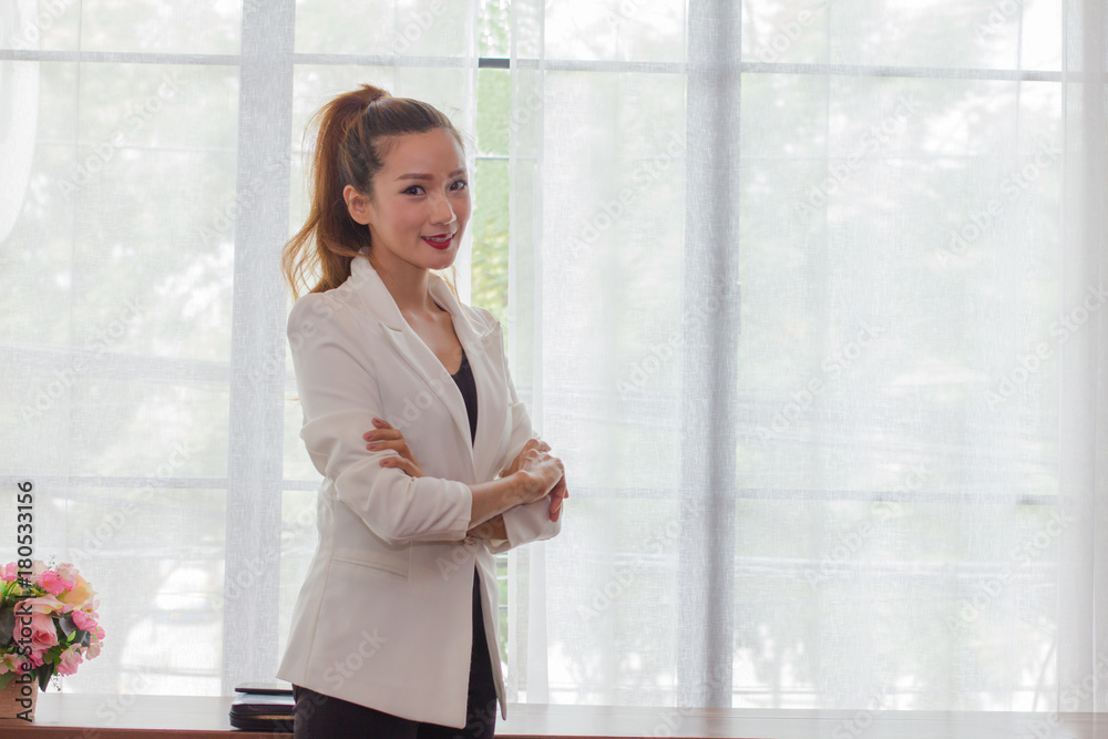 Asian business woman with bron long hair in white shirt sitting on office with copy space Asian business woman with bron long hair in white shirt sitting on office with copy space