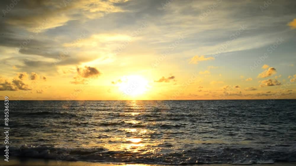 Sunset of sun setting over pacific ocean on windy evening Sunset of sun setting over pacific ocean on windy evening