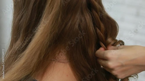 A professional stylist makes a hairstyle for the model. Fashion world.