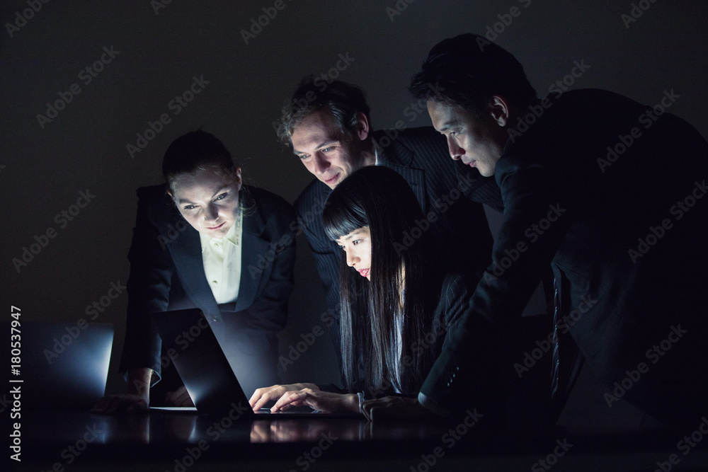 Group of people looking at screen of laptop PC.Group of people sitting ...