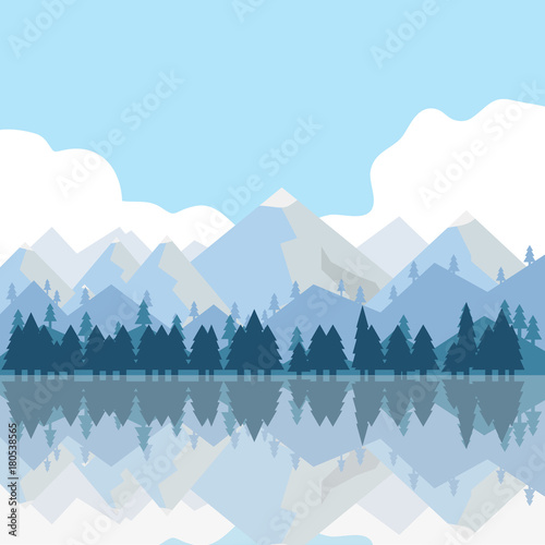 The mountains and trees are reflected in the water. Mountains, lake, trees, grass.