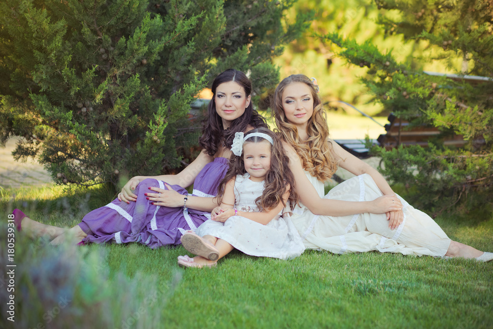 Stunning Brunette blond chestnut blue eyes sisters girls wearing stylish white purple dress enjoying life time together summer sunny day in garden forest on green grass happy smiling Stunning Brunette blond chestnut blue eyes sisters girls wearing stylish white purple dress enjoying life time together summer sunny day in garden forest on green grass happy smiling