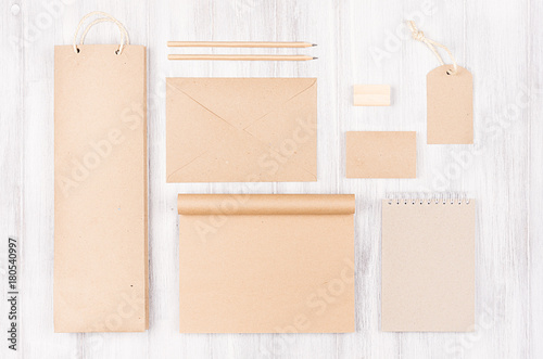 Corporate identity template, kraft packaging, stationery, gift set on soft white wood background. Mock up for branding, advertising, design.