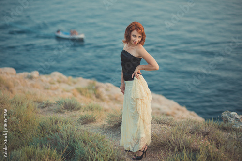 Romantic episode cosy Calendar seductive fresh lady girl woman red fire hair waiting her seaman dreams sea side full love memories wearing airy white long skirt black fashion shirt boats background photo