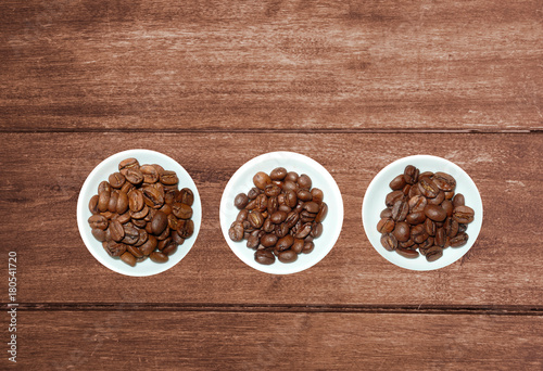variety of tea in strands and coffee beans on rustic wooden background