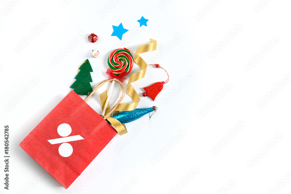 Christmas gifts falling from the red shopping bag, holiday presents isolated on white background, free copy space