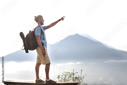Hiker man with backpack enjoy with volcano Batur, Indonesia