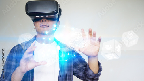 Young man wearing virtual reality glasses and touching on virtual screen. Virtual reality concept