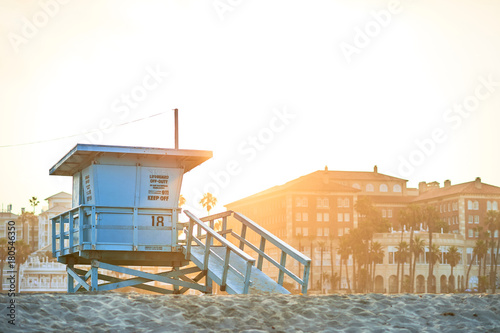 Sun rising behind a lifeguard booth in Santa Monica, Los Angeles, California