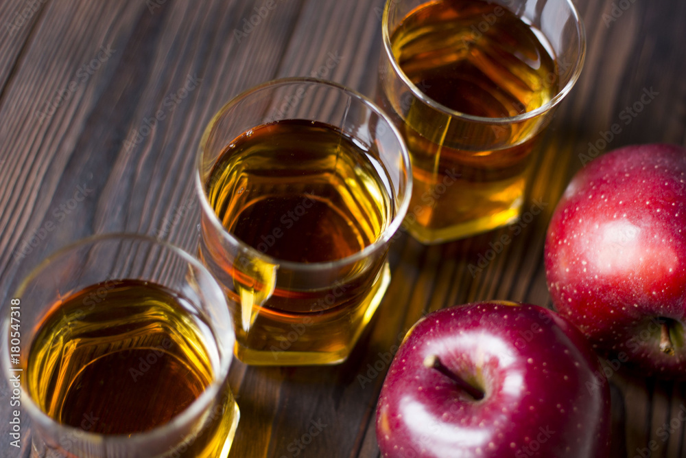 red Apple with Apple juice on a wooden table close up red Apple with Apple juice on a wooden table close up
