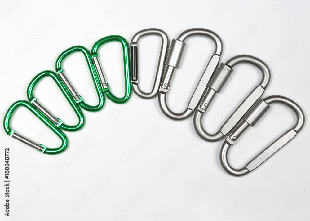 aluminum carabiners in a row on white background aluminum carabiners in a row on white background