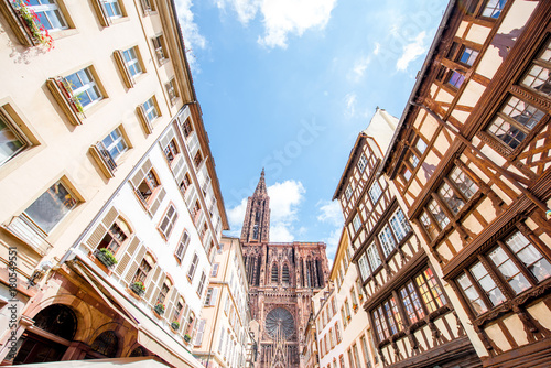 Street view from below on the beautiful old buildings and Notre-Dame cathedral in Strasbourg city, France