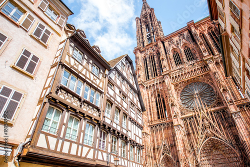 Street view from below on the beautiful old buildings and Notre-Dame cathedral in Strasbourg city, France photo