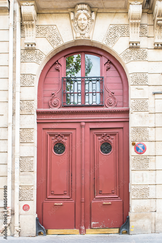 Fototapeta premium Paris, beautiful wooden red door, girder with sculptures 