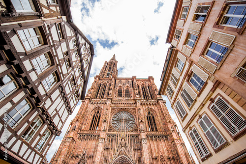 Street view from below on the beautiful old buildings and Notre-Dame cathedral in Strasbourg city, France photo