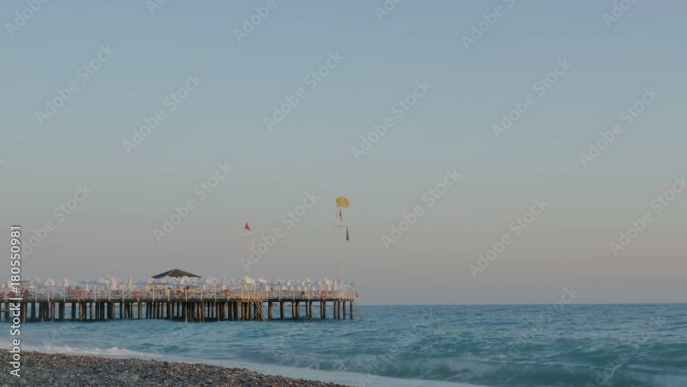 Beautiful view of the sea, pebble beach and pier. Sunset Beautiful view of the sea, pebble beach and pier. Sunset