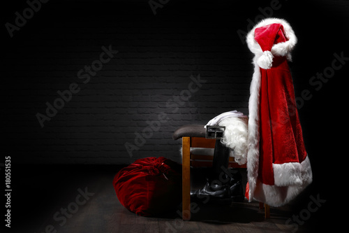 A chair in the house of Santa Claus and costumes on the back.