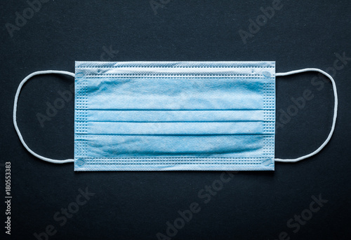 Disposable sterile surgical mask on black background