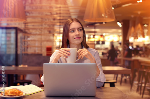 Young female marketing manager working in cafe