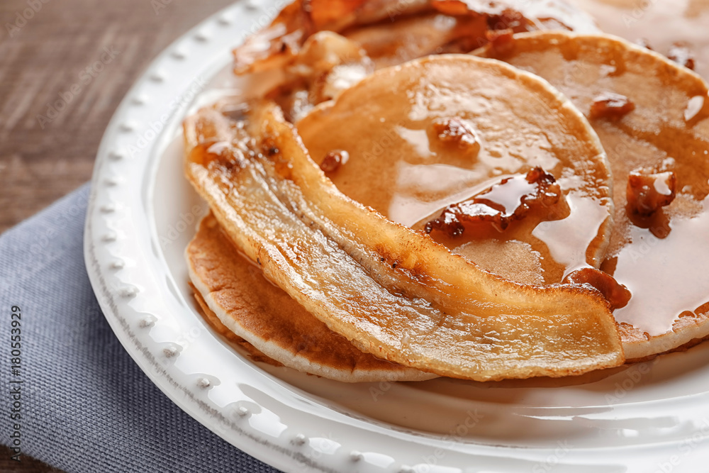Plate with pancakes, bacon and fried banana on table Plate with pancakes, bacon and fried banana on table