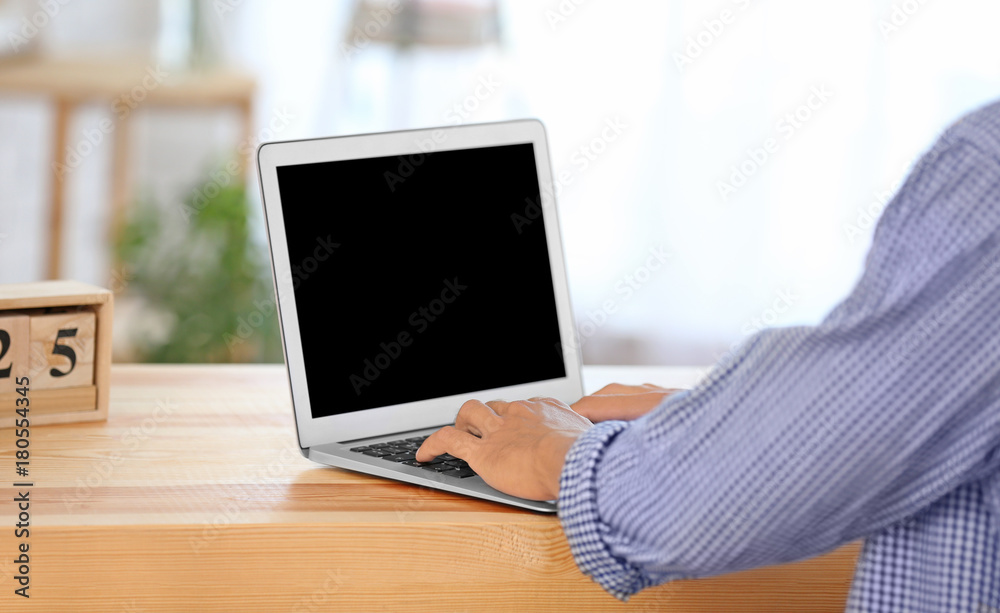 Young man using laptop at home Young man using laptop at home