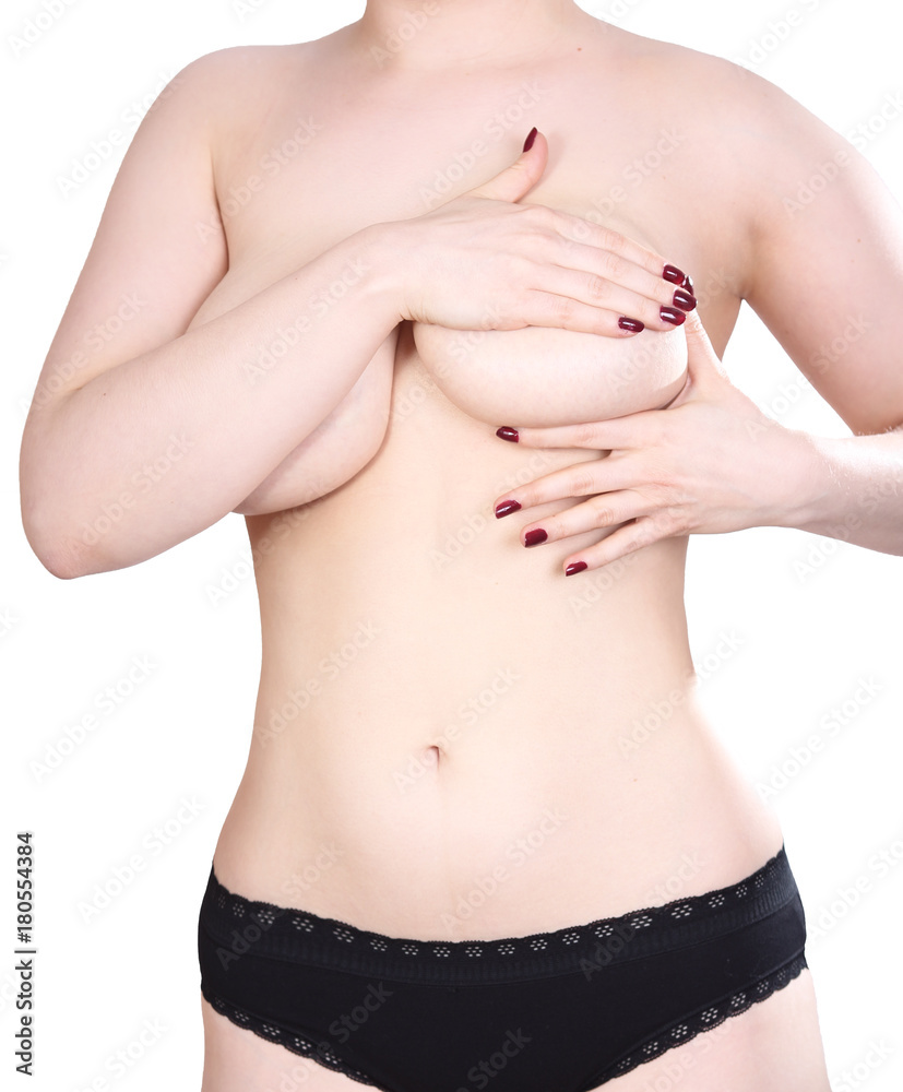 Woman examining her breasts on a white background
