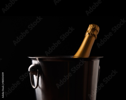 Picture of bottle of champagne in iron bucket