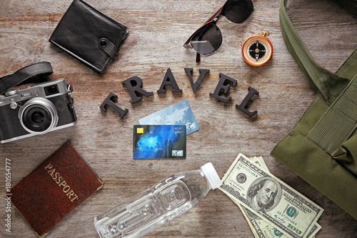 Tourist stuff with word TRAVEL on wooden background