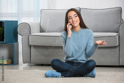 Young woman talking on mobi...
