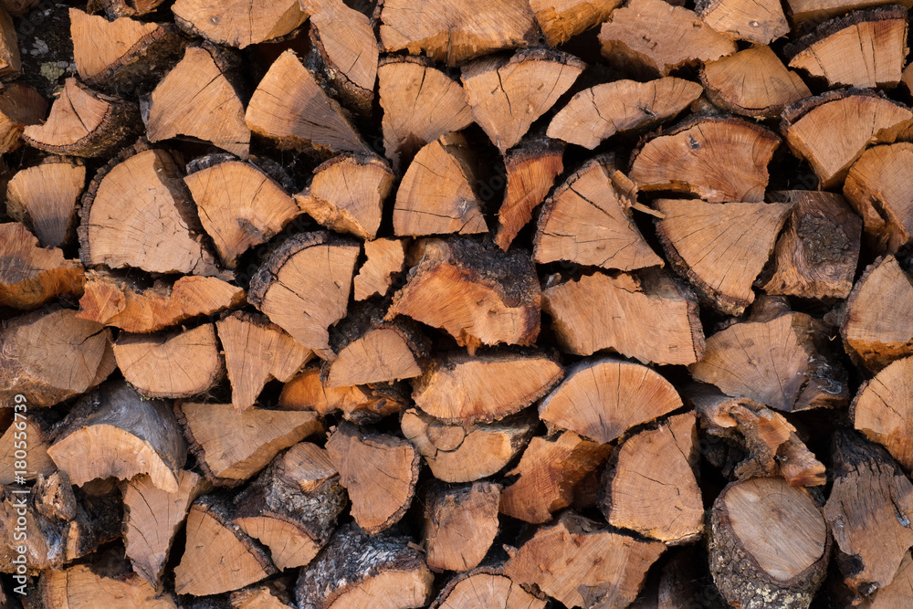 Background stack of wood logs for firewood Background stack of wood logs for firewood
