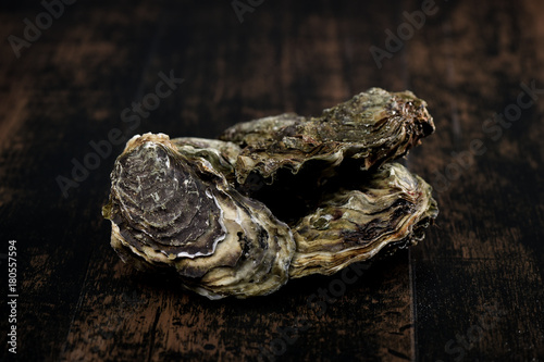Raw oysters on the wooden table, background