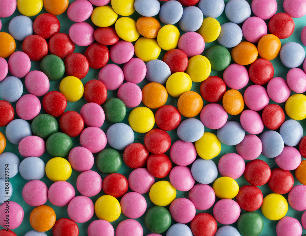 colorful chocolate candy pattern on mint blue background colorful chocolate candy pattern on mint blue background