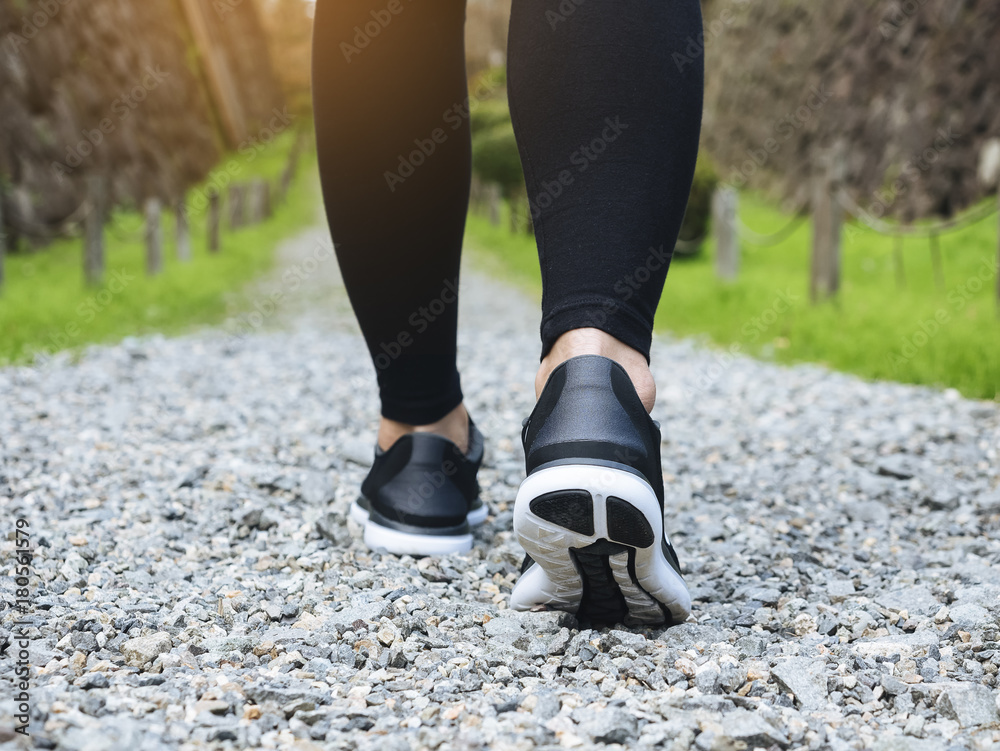 Trail walking woman legs with sport shoe Forest Park outdoor Travel adventure Trail walking woman legs with sport shoe Forest Park outdoor Travel adventure