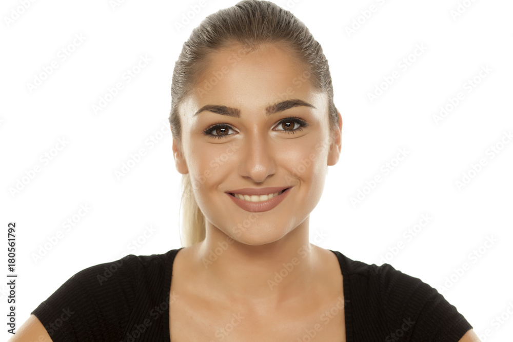 Portrait of a beautiful smiling teen girl on white background