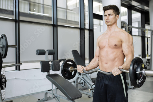 Muscular man bodybuilding in gym